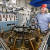 TJ Rowe stands by a point plant machine at the Fisher Space Pen factory in Boulder City Thursday, April 2, 2026. The machine takes blanks and makes them into the pointed part of the pen.