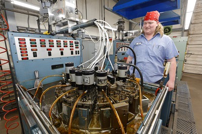TJ Rowe stands by a point plant machine at the Fisher Space Pen factory in Boulder City Thursday, April 2, 2026. The machine takes blanks and makes them into the pointed part of the pen.