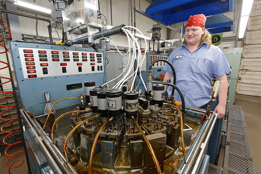 TJ Rowe stands by a point plant machine at the Fisher Space Pen factory in Boulder City Thursday, April 2, 2026. The machine takes blanks and makes them into the pointed part of the pen.