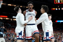 UConn forward Tarris Reed Jr., center, celebrates after the second half of an NCAA college basketball tournament semifinal game against Illinois at the Final Four, ...