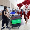 Showgirls welcome arriving passengers from France before a news conference at Harry Reid International Airport Wednesday, April 15, 2026. Officials celebrated the new non-stop Air France service between Las Vegas and Paris.