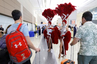 Showgirls welcome arriving passengers from France before a news conference at Harry Reid International Airport Wednesday, April 15, 2026. Officials celebrated the new non-stop Air France service between Las Vegas and Paris.