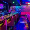 The interior of Society Lounge, a cannabis consumption space on Paradise Road attached to The Grove dispensary, gleams under colorful lighting.