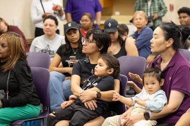 Las Vegas Aces assistant coach Larry Lewis reads to a roomful at the Alexander Library Wednesday April 22, 2026 during the unveiling of the new special edition “Aces” library card for the North Las Vegas Library&nbsp;District.