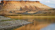 Nick Gann fishes in Firehole Canyon, Friday, Aug. 5, 2022, on the far northeastern shore of Flaming Gorge Reservoir, in&nbsp;Wyoming. 

