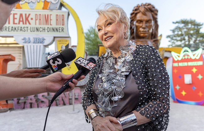 Lynette Chappell, the “evil queen” in the Siegfried & Roy show, is interviewed before a lighting ceremony for the restored 3,600-lb. Siegfried & Roy statue at the Neon Museum Friday, April 24, 2026. The statue, previously located in front of the Mirage on The Strip for more than 30 years, was donated to the museum after Hard Rock International acquired the property.