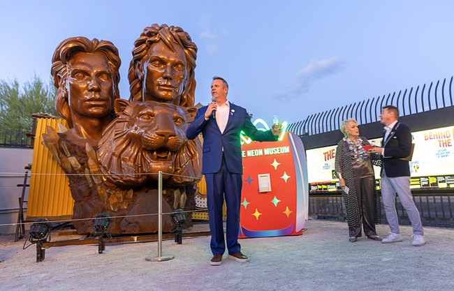 Adam Barthelmess, center, board chairman of the Neon Museum, speaks during a lighting ceremony for the restored 3,600-lb. Siegfried & Roy statue at the museum Friday, April 24, 2026. The statue, previously located in front of the Mirage on The Strip for more than 30 years, was donated to the museum after Hard Rock International acquired the property.