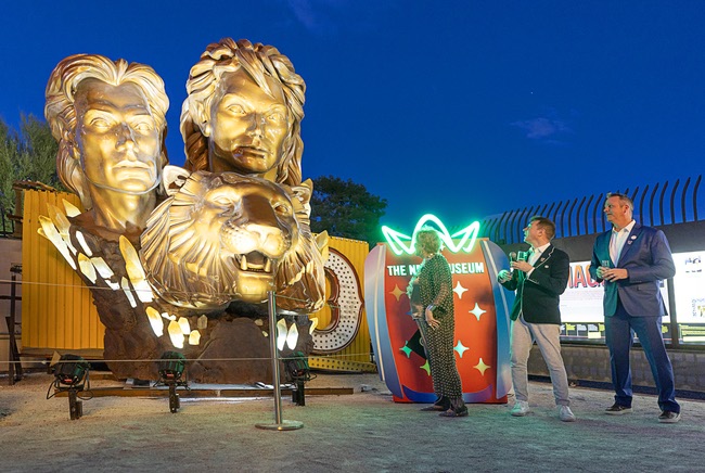 Lights illuminate the restored 3,600-lb. Siegfried & Roy statue during a ceremony at the Neon Museum Friday, April 24, 2026. Looking on from left, are: Lynette Chappell, the “evil queen” in the Siegfried & Roy show, Aaron Berger, center, executive director/CEO of the Neon Museum, and Adam Barthelmess, museum board chairman. The statue, previously located in front of the Mirage on The Strip for more than 30 years, was donated to the museum after Hard Rock International acquired the property.
