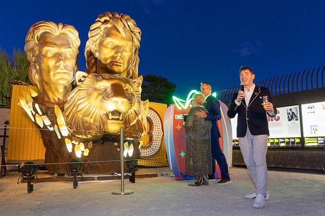 Aaron Berger, right, executive director/CEO of the Neon Museum, speaks during a lighting ceremony for the restored 3,600-lb. Siegfried & Roy statue during a ceremony at the museum Friday, April 24, 2026. Also pictured are: Lynette Chappell, the “evil queen” in the Siegfried & Roy show, and Adam Barthelmess, museum board chairman. The statue, previously located in front of the Mirage on The Strip for more than 30 years, was donated to the museum after Hard Rock International acquired the property.
