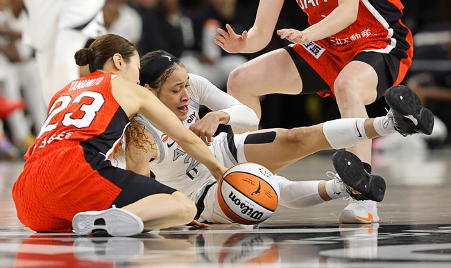Las Vegas Aces guard Chennedy Carter (23) and Japan national team guard Mai Yamamoto (23) fight for a loose ball during the second half of an exhibition game at Michelob Ultra Arena at Mandalay Bay Sunday, April 26, 2026.