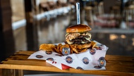 For 2026, the Aviators’ home is rolling out wood-fired pizza, Philly steaks, Hawaiian-inspired plates, taco carts, smash burgers and a menu that reads like someone raided the city’s food scene and put it in the grandstand behind home plate.