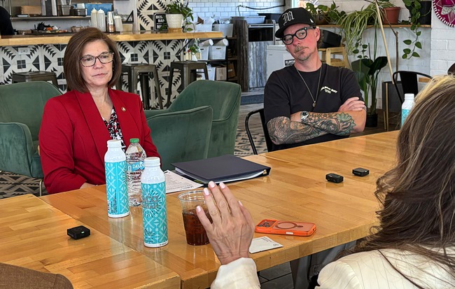Sen. Catherine Cortez Masto, left, D-Nev., listens to business owners during a small business event at Tacotarian in the Arts District Thursday, May 7, 2026. Austin Spencer, owner of Studio 21 Tattoo, listens at right.
