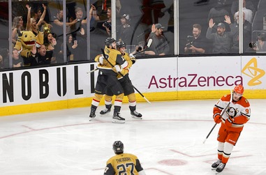 Vegas Golden Knights right wing Pavel Dorofeyev, center right, celebrates with Vegas Golden Knights defenseman Ben Hutton (17) after scoring against the Anaheim Ducks in overtime of Game 5 of a second-round NHL hockey Stanley Cup playoff series at T-Mobile Arena Tuesday, May 12, 2026, in Las Vegas Anaheim Ducks center Leo Carlsson (91) skates away at&nbsp;right.