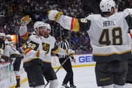 Vegas Golden Knights defenseman Dylan Coghlan, front left, is congratulated after scoring a goal by defenseman Shea Theodore, back left, and center Tomas Hertl during the second period in Game 1 of the Western Conference finals NHL hockey Stanley Cup playoff series against the Colorado Avalanche Wednesday, May 20, 2026, in&nbsp;Denver.