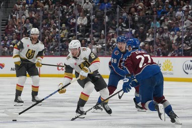 Vegas Golden Knights center Jack Eichel (9) drives with the puck as Colorado Avalanche defenseman Brett Kulak (27) and center Martin Necas (88) defend while Golden Knights defenseman Noah Hanifin (15) trails the play during the second period in Game 2 of the Western Conference finals NHL hockey Stanley Cup playoff series Friday, May 22, 2026, in&nbsp;Denver.
