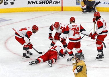 Carolina Hurricanes players surround center Jordan Staal (11) after his go-ahead goal against the Vegas Golden Knights during the third period in Game 4 of the NHL hockey Stanley Cup Final series at T-Mobile Arena Tuesday, June 9, 2026, in Las Vegas. Vegas Golden Knights right wing Pavel Dorofeyev (16) skates away at bottom&nbsp;right.