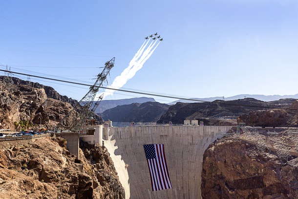 The United States Air Force Thunderbirds, the official aerial demonstration team of the U.S. Air Force, perform a flyover above Hoover Dam, adorned with a 300-foot-wide by 150-foot-tall American flag, near Boulder City, Nev. Tuesday, June 30, 2026. The Thunderbirds will travel to Washington, D.C., for the Salute to America250 celebration.