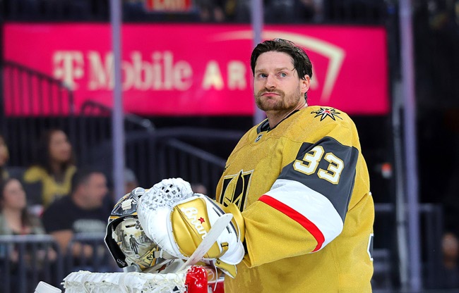 Vegas Golden Knights goaltender Adin Hill (33) takes off his face mask during a break in the second period of game one in an NHL hockey Stanley Cup first-round playoff series against the Minnesota Wild at T-Mobile Arena Sunday, April 20, 2025.