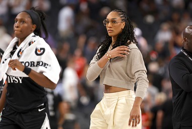Las Vegas Aces center A’ja Wilson, right, joins guard Chelsea Gray (12) and other players on the court after a 84-68 loss to the Indiana Fever during the second half of an WNBA basketball game at T-Mobile Arena Sunday, July 5, 2026. Wilson did not play due to an ankle&nbsp;injury.