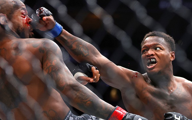 King Green, left, takes a punch from Terrance McKinney in a lightweight bout during UFC 329 at T-Mobile Arena Saturday, July 11, 2026. Green defeated by TKO in the first round.