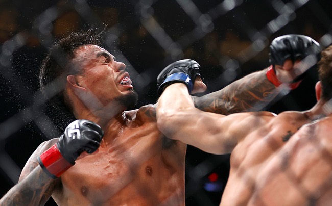 Brandon Royval takes a punch from Lone’er Kavanagh in a flyweight bout during UFC 329 at T-Mobile Arena Saturday, July 11, 2026. Royval defeated Kavanagh by submission in the third round.