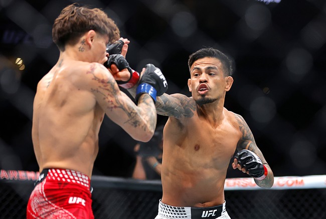 Brandon Royval, right, punches Lone’er Kavanagh in a flyweight bout during UFC 329 at T-Mobile Arena Saturday, July 11, 2026. Royval defeated Kavanagh by submission in the third round.
