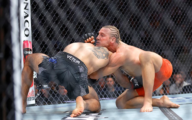 Paddy Pimblett, right, grapples with Benoit Saint-Denis in a lightweight bout during UFC 329 at T-Mobile Arena Saturday, July 11, 2026. Pimblett defeated Saint-Denis by submission in the first round.