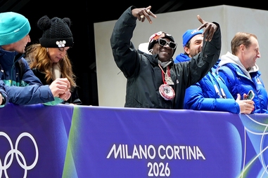 American rapper Flavor Flav attends the 2026 Winter Olympics in Italy. His support for female U.S. Olympians at the Milan-Cortina Games culminates this week in Las Vegas for SHE Weekend, with the iconic Las Vegas sign glowing pink to honor the&nbsp;competitors.
