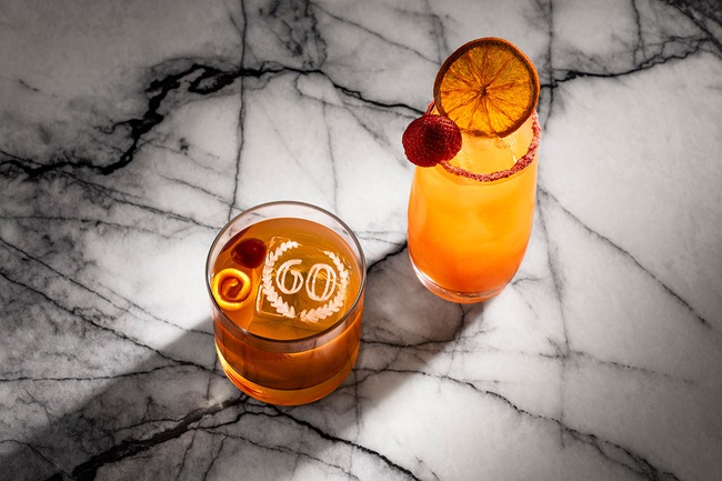 Caesars Palace's 60th Anniversary Old Fashioned, left, features a commemorative ice cube etched with the number 60, while the Strawberry Wallbanger is garnished with a dried orange slice and fresh strawberry.