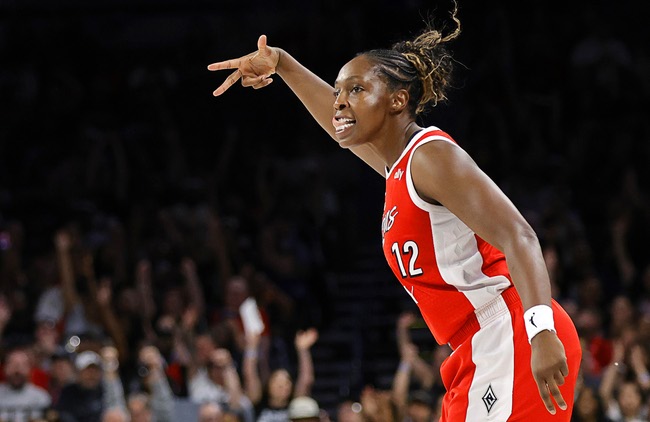 Las Vegas Aces guard Chelsea Gray (12) celebrates after making a three-point basket against the New York Liberty during the first half of an WNBA basketball game at Michelob Ultra Arena in Mandalay Bay Thursday, July 30, 2026.