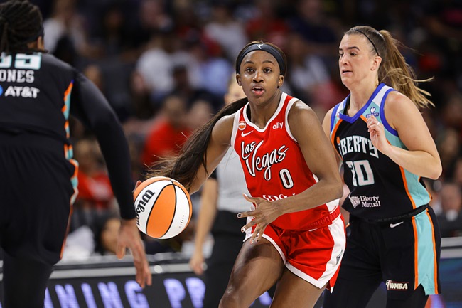 Las Vegas Aces guard Jackie Young (0) drives between New York Liberty center Jonquel Jones, left, and guard Sabrina Ionescu (20) during the first half of an WNBA basketball game at Michelob Ultra Arena in Mandalay Bay Thursday, July 30, 2026.