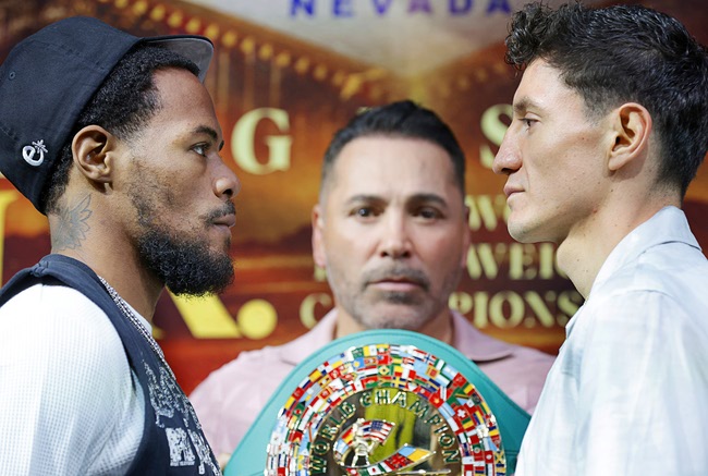Lamont Roach Jr., left, and William Zepeda face off during a news conference at Virgin Las Vegas Thursday, July 30, 2026. The boxers are scheduled to fight for a vacant WBC lightweight title at the casino on Saturday. Boxing promoter Oscar De La Hoya holds the title belt.