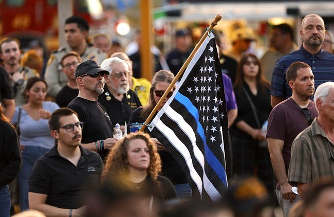 Hundreds of people attend a vigil for slain Metro Police officer Austin Abdelnabi at Police Memorial Park Friday, Aug. 7, 2026. Officer Abdelnabi was shot and killed in the line of duty on Tuesday, Aug. 4.