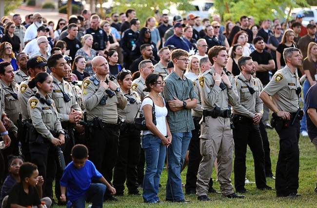 Hundreds of people attend a vigil for slain Metro Police officer Austin Abdelnabi at Police Memorial Park Friday, Aug. 7, 2026. Officer Abdelnabi was shot and killed in the line of duty on Tuesday, Aug. 4.