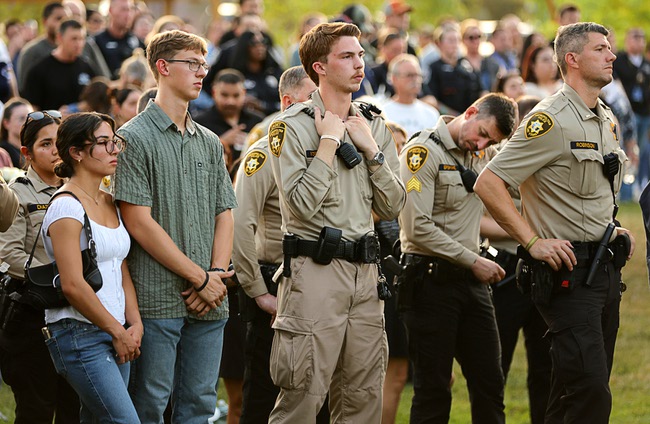 Hundreds of people attend a vigil for slain Metro Police officer Austin Abdelnabi at Police Memorial Park Friday, Aug. 7, 2026. Officer Abdelnabi was shot and killed in the line of duty on Tuesday, Aug. 4.