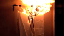 A company lights a curtain on fire to showcase their fire suppression system at the 2013 NAHB Builders' Show.